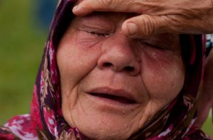  A Bosniak woman Senija Rizvanovic cries near the graves of her two sons, in Srebrenica, Bosnia. Photo by Amel Emric/AP